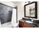 Bathroom features a dark tiled shower, framed mirror, and coordinating countertop at 12775 Horizon Trl, Castle Pines, CO 80108