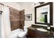 Cozy bathroom with dark wood cabinets and a shower-tub combo at 12775 Horizon Trl, Castle Pines, CO 80108