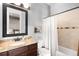 Bathroom featuring granite countertop, decorative backsplash, and shower with curtain at 12775 Horizon Trl, Castle Pines, CO 80108