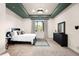 Bright bedroom with a ceiling detail, window, area rug and full size dresser at 12775 Horizon Trl, Castle Pines, CO 80108