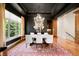 Dining room with dark ceiling, chandelier, light-colored curtains, and hardwood floors at 12775 Horizon Trl, Castle Pines, CO 80108