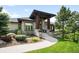 Stone and paneled home with wooden beams and a landscaped yard at 12775 Horizon Trl, Castle Pines, CO 80108