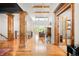 Grand foyer featuring wood columns, wood floors, and ample natural light at 12775 Horizon Trl, Castle Pines, CO 80108