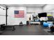 A spacious home gym with workout equipment and an American flag at 12775 Horizon Trl, Castle Pines, CO 80108