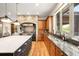 Well-equipped kitchen with granite countertops, custom cabinetry, and hardwood floors at 12775 Horizon Trl, Castle Pines, CO 80108