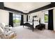 A bedroom featuring dark trim, an antler chandelier, and picturesque windows at 12775 Horizon Trl, Castle Pines, CO 80108