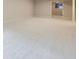 Spacious carpeted basement featuring neutral walls and bright, natural light through a window at 15224 W 73Rd Ave, Arvada, CO 80007