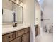 Stylish bathroom featuring a modern sink, tile flooring, skylight, and bath/shower combination at 15224 W 73Rd Ave, Arvada, CO 80007