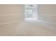 Spacious bedroom featuring neutral walls, plush carpeting, ceiling fan, and a sunny bay window area at 15224 W 73Rd Ave, Arvada, CO 80007