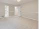 Bright bedroom featuring chair rail molding, plush carpet, and access to other rooms and en suite bathroom at 15224 W 73Rd Ave, Arvada, CO 80007
