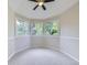 Bright bedroom featuring a vaulted ceiling, ceiling fan, and a large window overlooking a green landscape at 15224 W 73Rd Ave, Arvada, CO 80007