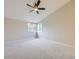 Spacious bedroom with a large window and ceiling fan at 15224 W 73Rd Ave, Arvada, CO 80007