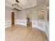 Open dining room featuring elegant trim work, hardwood floors, and modern lighting at 15224 W 73Rd Ave, Arvada, CO 80007