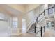 Bright foyer featuring a stairway, elegant chandelier, and hardwood floors at 15224 W 73Rd Ave, Arvada, CO 80007