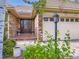 Beautiful front entryway with a brick entryway, flower pots, and a glass paneled door at 15224 W 73Rd Ave, Arvada, CO 80007