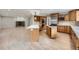 Open kitchen featuring custom cabinets, a large island, and modern appliances at 15224 W 73Rd Ave, Arvada, CO 80007