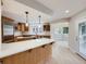 Bright kitchen showcasing a center island with a cooktop and stainless steel appliances at 15224 W 73Rd Ave, Arvada, CO 80007