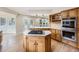 Modern kitchen with an island cooktop, stainless appliances, and hardwood floors at 15224 W 73Rd Ave, Arvada, CO 80007