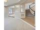 Bright, open-concept living room with hardwood floors, a staircase, and neutral walls at 15224 W 73Rd Ave, Arvada, CO 80007