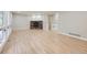 Bright living room with hardwood floors and a brick fireplace, perfect for relaxing or entertaining at 15224 W 73Rd Ave, Arvada, CO 80007