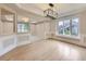 Sun-lit living room with wainscoting and hardwood floors, offering a blend of comfort and style at 15224 W 73Rd Ave, Arvada, CO 80007
