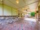 Covered patio with brick pillars, ceiling fan, and decorative lighting, ideal for outdoor living at 15224 W 73Rd Ave, Arvada, CO 80007