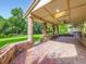 Charming brick patio with brick columns and ceiling fans, perfect for outdoor entertaining and relaxation at 15224 W 73Rd Ave, Arvada, CO 80007