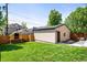 Well-maintained backyard featuring a lush lawn, privacy fencing, and accessory structure at 1241 S Garfield St, Denver, CO 80210