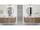 Bright bathroom featuring dual vanities with marble countertops, round mirrors, and stylish sconces at 1241 S Garfield St, Denver, CO 80210