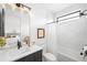 Chic bathroom featuring a bathtub, modern vanity, and a decorative mirror reflecting the bedroom at 1241 S Garfield St, Denver, CO 80210
