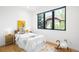 Bright bedroom featuring a large window, hardwood floors, and playful decor at 1241 S Garfield St, Denver, CO 80210