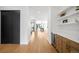 Bright hallway featuring hardwood floors, a wet bar, and seamless access to the dining area at 1241 S Garfield St, Denver, CO 80210