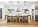 Modern kitchen featuring a large island, stainless steel appliances, pendant lighting, and seamless access to the living area at 1241 S Garfield St, Denver, CO 80210