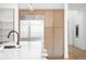 Modern kitchen area with built-in refrigerator and cabinets, white countertop and light fixtures at 1241 S Garfield St, Denver, CO 80210