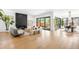 Bright living room boasts a modern fireplace, seamless access to the patio, and open layout to the dining area at 1241 S Garfield St, Denver, CO 80210