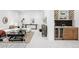 Spacious living room with a bar area featuring a wine cooler and custom shelving at 1241 S Garfield St, Denver, CO 80210