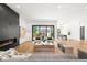 Bright living room with fireplace, hardwood floors, and indoor-outdoor living at 1241 S Garfield St, Denver, CO 80210