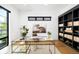 Well-lit home office featuring a large window, modern shelving, and a stylish desk with an artistic pelican at 1241 S Garfield St, Denver, CO 80210