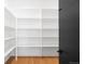 Walk-in pantry featuring white shelves and hardwood floors, offering ample storage space at 1241 S Garfield St, Denver, CO 80210