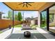 Charming covered patio boasts an outdoor lounge area, fire pit, and views of the landscaped backyard at 1241 S Garfield St, Denver, CO 80210