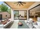 Charming covered patio boasts an outdoor lounge area and views into the dining room and kitchen at 1241 S Garfield St, Denver, CO 80210