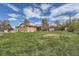 Large backyard with established lawn, covered patio, and storage shed at 755 Braun St, Lakewood, CO 80401
