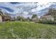 Large backyard featuring lush green grass and mature trees at 755 Braun St, Lakewood, CO 80401