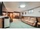Finished basement with bar, exercise equipment, and comfortable seating area at 755 Braun St, Lakewood, CO 80401