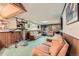 Spacious basement area with stone fireplace, exercise equipment, and comfortable seating at 755 Braun St, Lakewood, CO 80401