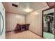 Unfinished basement area with paneled walls, tile floor and utility access at 755 Braun St, Lakewood, CO 80401