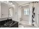 Modern bathroom with black granite sink, tile shower, and updated fixtures at 755 Braun St, Lakewood, CO 80401