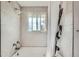 Bathroom with shower-tub combination with tiled walls and a window at 755 Braun St, Lakewood, CO 80401