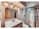 Bathroom with new vanity, updated light fixtures, and shower at 755 Braun St, Lakewood, CO 80401