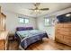 Bright bedroom with hardwood floors, ceiling fan and natural light from two windows at 755 Braun St, Lakewood, CO 80401